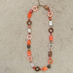 Long beaded necklace with fun shapes. Lightly used.